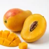 Ripe mango fruit with one whole fruit and sliced pieces showing juicy yellow flesh
