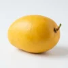 Close-up of Sindhu Mango fruit showing golden-yellow skin and smooth texture.